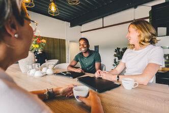 Three employees in a good mood during a conversation
