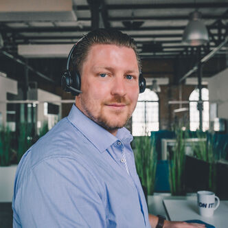 Employee with headset looks into the camera