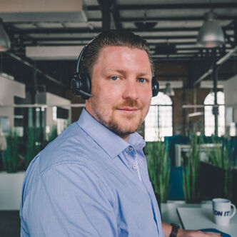 Employee with headset looks into the camera