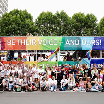 Employees in front of a Bertelsmann "be.queer" truck on Christopher Street Day in Berlin